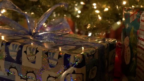 Slow Pan Over Festive Wrapped Present Under Christmas Tree Stock Footage 83360262