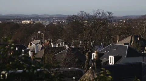 Slow pan over rooftops with bus Stock Footage 21894341