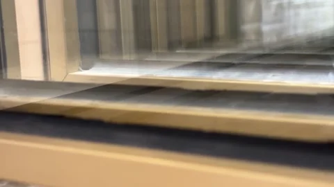 Slow Pan of Reflective Golden Window Frame Trim with Layered Reflection Vídeos de archivo 332662670