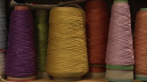 Slow Pan Right Across Multi Coloured Reels of Yarn Stock Footage 57270564