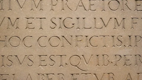 Slow pan from right to left over old roman text letters words in Latin language Stock Footage 124799860