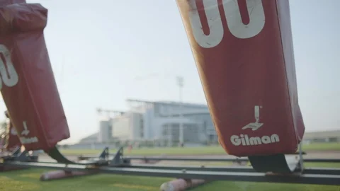 Slow pan right to left of tackling dummies on football field Stock Footage 104768181