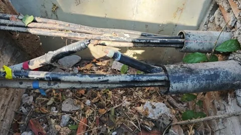 Slow pan right video of damaged underground high voltage power cable. Video stock 328519761