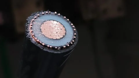 Slow pan right video of a freshly cut underground electrical power cable. Stock Footage 338355536