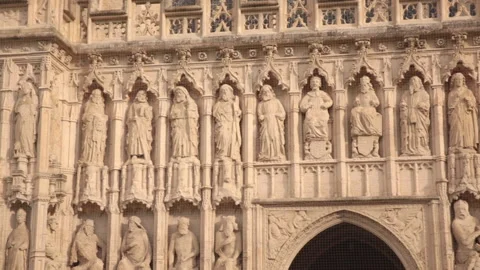 Slow pan of row of statues on facade of Exeter Cathedral Stock Footage 142322468