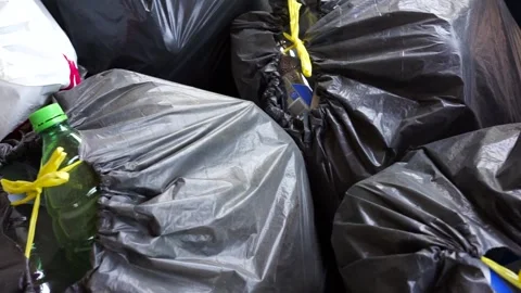 Slow pan shot, empty plastic bottles in big black garbage sacks Stock Footage 310874669