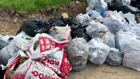 Slow pan shot, human garbage in plastic bags Stock Footage 194363779