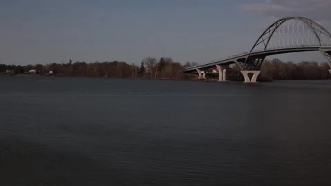 Slow pan shot right to left. Lake Champlain Bridge to Lake Champlains edge. Stock Footage 273607974