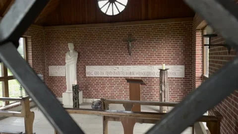 Slow pan shot showing small catholic church chapel on mountain in germany. Video stock 146157252