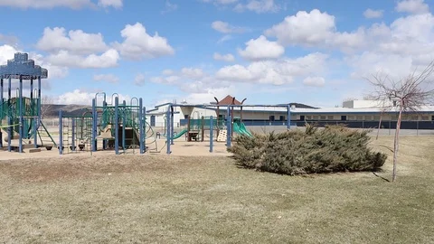 Slow Pan of Shut Down Playground with Caution Tape Stock Footage 127326895