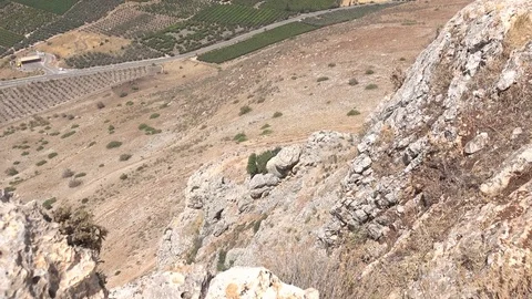 Slow Pan Up Side of Cliff to Sea of Galilee in Distance Stock Footage 78247482