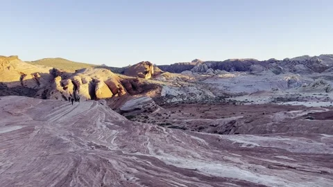 Slow Pan from Sunlit Red Rocks to Pale Sandstone Basin at Valley of Fire Stock Footage 307657713