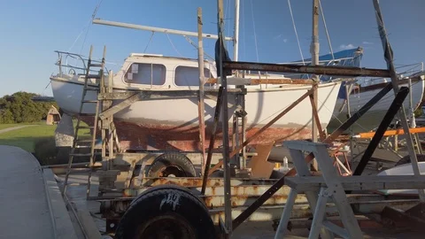 Slow pan through a rustic boat yard out into the bay Stock Footage 107598528