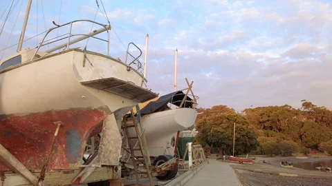 Slow pan through a rustic boat yard out into the bay Stock-Footage 107649934