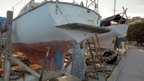 Slow pan through a rustic boatyard out into the bay Stock-Footage 107600571
