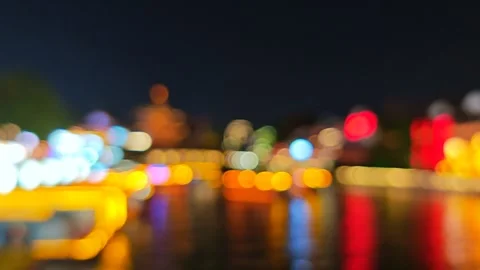 A slow pan through a vibrant cityscape at night, capturing the reflection of Video stock 338235317