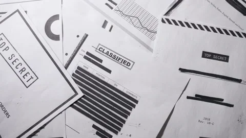 Slow pan top down shot on top secret classified documents laid on table Stock Footage 138440773