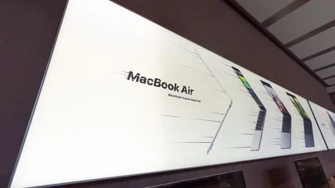 Slow pan ultra-wide of MacBook Air with M2 - large interior advertising banner Stock Footage 224883352