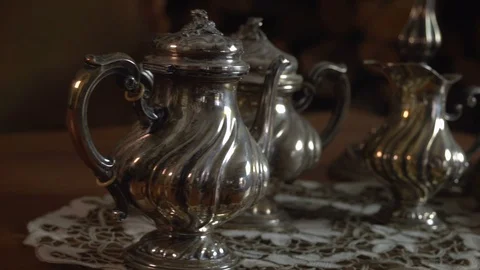 Slow panning close up on vintage silverware teapot milk pan and sugar bowl FDV 動画素材 120793585