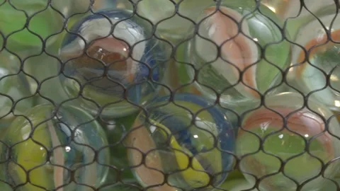 Slow panning closeup of a net transparent bag full of colorful multicolored Stock Footage 320929327