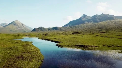 Slow panning drone shot of Scotland Highlands with small river water Stock Footage