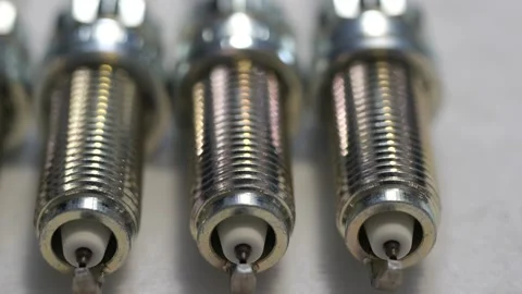 Slow panning of fresh clean spark plugs for car mechanics Stock Footage 258095945