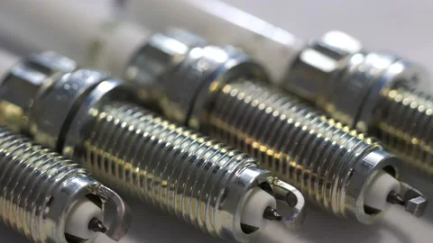 Slow panning of fresh clean spark plugs for car mechanics Stock Footage 258095955