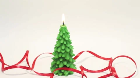 Slow panning from left to right of burning candle in shape of fir tree Stock Footage 143660145