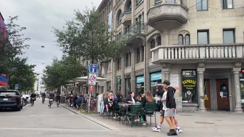 Slow Panning Mid Shot View of Bikers and Pedestrians at Zurich Stock Footage 214220282