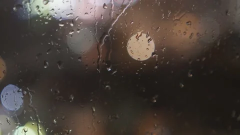 Slow panning of nighttime rainy window with city light bokeh Stock Footage 157666188