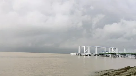 Slow Panning Riverside Scene with Jetty and Cloudy Sky in 4K Stock Footage 338244765