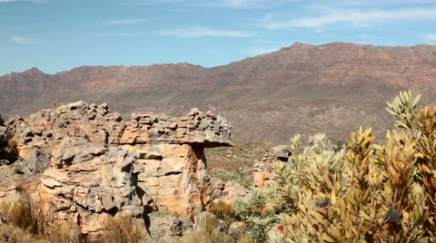 Slow panning shot across remote rocky scene with mountain range Stock Footage 54226687