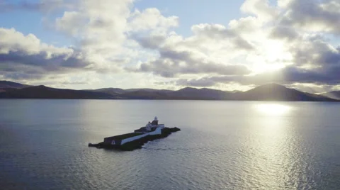 Slow panning shot of lighthouse amidst ocean Stock Footage 62554537
