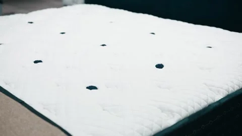Slow panning shot of a plush white mattress cushion showcasing softness Stock Footage 305156154
