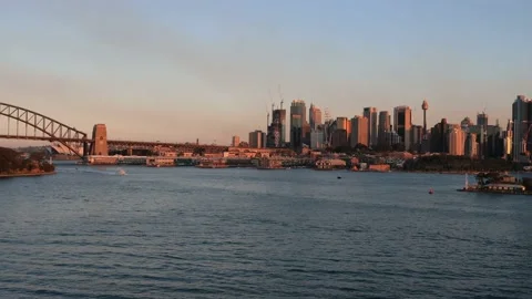 Slow panning of Sydney CBD waterfront across harbour at sunset in 4k. Stock Footage 138904636