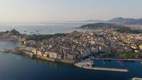 Slow panoramic pan drone shot of Corfu old town during sunrise Stock Footage 319749091
