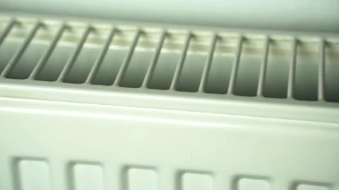 Slow panoramic shot over a white radiator Stock Footage 322114557