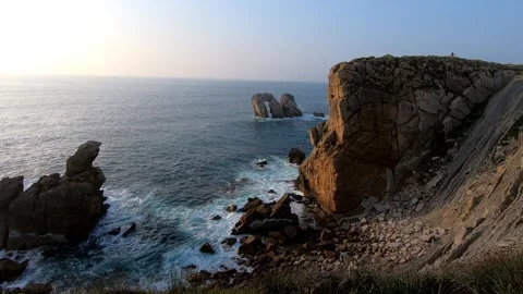 Slow panoramic view of coastal cliffs, rocky shoreline and the iconic sea s.. Stock Footage 343227459