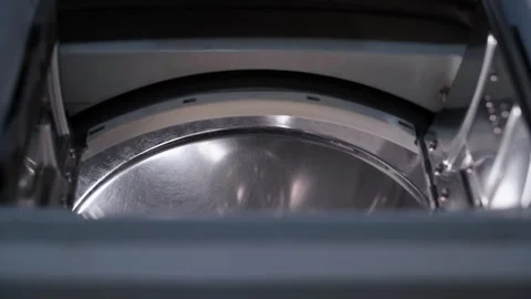 Slow peeking into a top-loading washing machine. Smooth movement of the camera Stock Footage 247425120