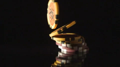 SLOW: A playing chips falls on a black desk Stock Footage 61033512