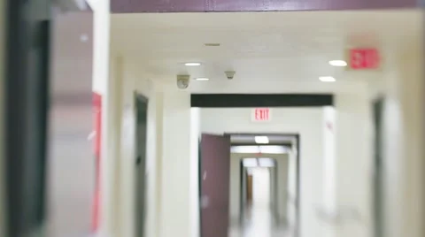 Slow POV walk inside white hospital hallway corridor. Defocused blurred vision. Stock Footage