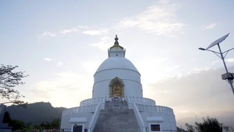 Slow pull back from Peace Pagoda in Pokhara, Nepal at sunset Video stock 91166227