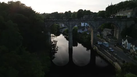 Slow pull back reveal over glass like River Nidd with clear reflections showing Stock-Footage 321440228