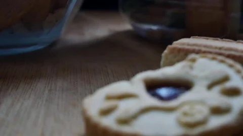 Slow pull back shot revealing 3 biscuits pile on wooden surface. Stock Footage 98972111