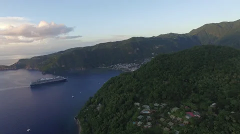 Slow pull in to mountain and town with cruise ship docked near bay Video stock 66340085