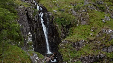 Slow pull up shot of a cascading waterfalls in Scotland Stock Footage 116042509
