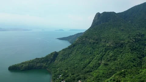 Slow pullback aerial shot of mountain slopes leading toward expansive views of Видео 336705384