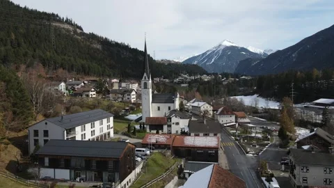 Slow pullback from alpine village church tower Stock Footage 331900359
