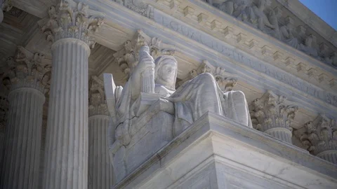 Slow push in closeup of sculpture on the Supreme Court building of The Three Vídeos de archivo 128384089