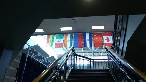 Slow Push Forward Toward Stairs In Public Building Revealing Multiple Nation Stock-Footage 125539783